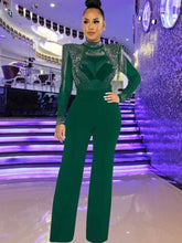 Jumpsuit mit langen Ärmeln und gepolsterten Schultern und Quasten